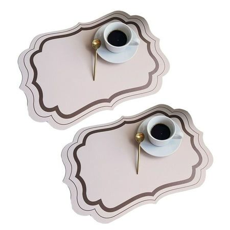 two white trays with coffee cups on them, one has gold pins in the middle