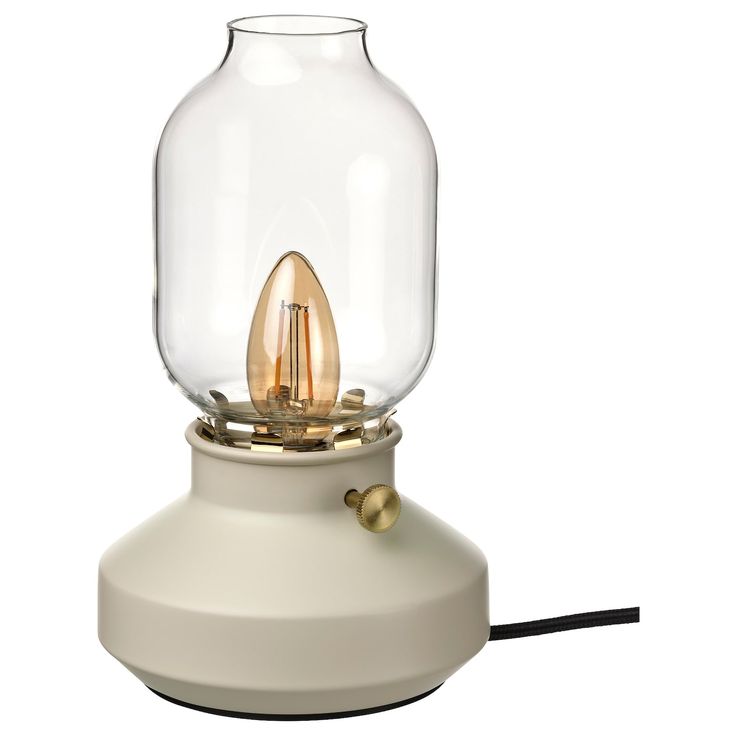 a light that is sitting on top of a white table lamp with a black cord in front of it