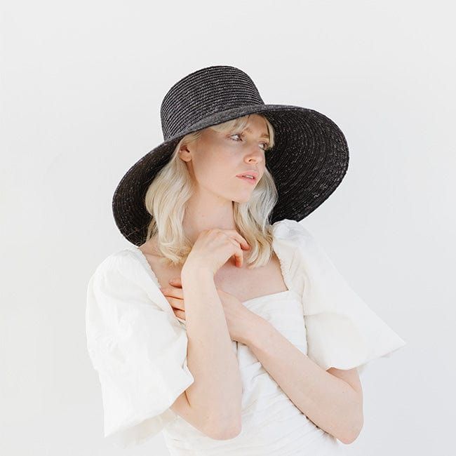 Jolie is a showstopper with an ultra-classic silhouette. Braided from all-natural wheat straw, its unique weave gives this bell-shaped hat depth + texture that continues through the sloped brim. Jolie's bold + beautiful style inspires major confidence. Limited Edition Jolie has been moved to its own page! To shop, click HERE! Limited Edition Jolie is a relaxed, modern take on the bestselling Jolie. This elevated Raffia material creates movement while keeping the wide brim + tall crown this style Adjustable Black Straw Hat Made Of Paper Straw, Modern Curved Brim Hats For Spring, Modern Spring Hats With Curved Brim, Modern Spring Hat With Curved Brim, Modern Flat Brim Summer Hat, Modern Wide Brim Hat For Spring, Modern Curved Brim Hats For Summer, Modern Summer Hat With Curved Brim, Black Toquilla Straw Panama Hat For Summer