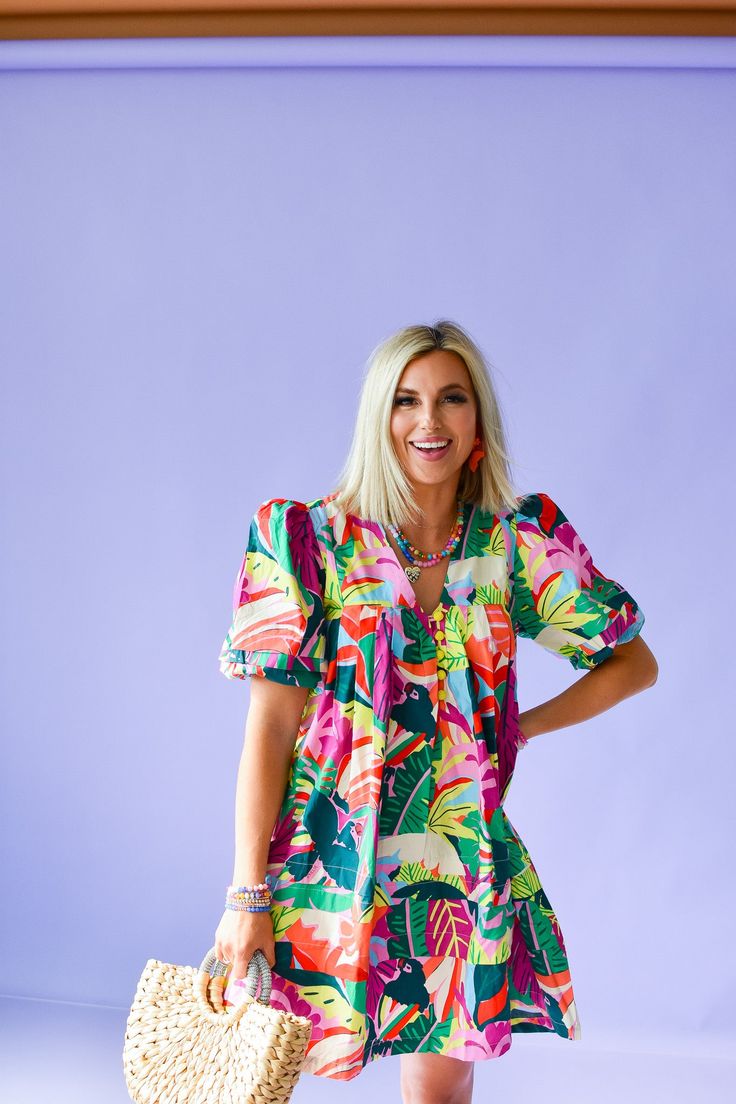 Get ready to turn heads in the Mitzi Print Mini Dress! This playful dress features a tropical floral print in bright, vibrant colors that will make you stand out in any crowd. With beaded buttons and a puff sleeve, this cotton poplin dress is perfect for a day out on the town. Product Details: Measurements: BUST small 19" medium 20" large 21" LENGTH small 35" medium 36" large 37" cotton poplin beaded buttons puff sleeve flowy fit model wearing size small model stats: size 4, 5'5 Multicolor Tropical Mini Dress For Day Out, Tropical Multicolor Mini Dress For Vacation, Tropical Multicolor Dress For Day Out, Multicolor Floral Print Mini Dress With Puff Sleeves, Cotton Dress With Vibrant Print For Vacation, Fun Floral Print Vacation Dress, Spring Tropical Mini Dress With Short Sleeves, Tropical Dress With Vibrant Print For Day Out, Cotton Tropical Print Dress For Day Out