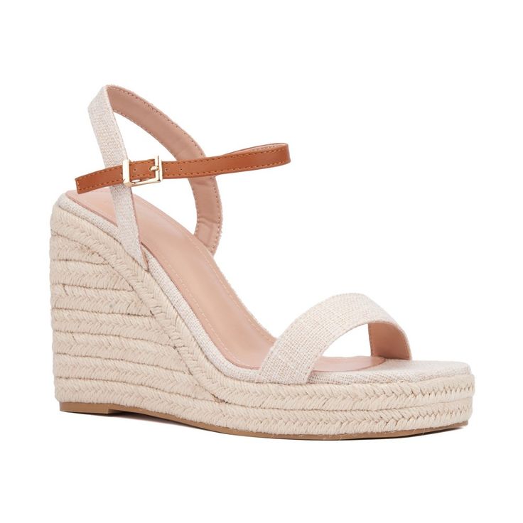 A summer style essential, the Unita espadrille sandal features platform wedge heels that provide both height and comfort. Contrasting ankle straps add a distinctive touch to the design, while polished buckle closures enhance the sandal's sophisticated appeal. Perfect for pairing with sundresses, shorts, or skirts, the Unita sandal effortlessly combines chic style with practicality. Elevate your warm-weather wardrobe with this versatile espadrille, ideal for adding a touch of elegance and ease to Adjustable Ankle Strap Wedge Sandals For Summer, Trendy Espadrille High Heels, Trendy Summer Espadrille Heels, Spring Espadrille Wedge Heels, Adjustable Summer Wedge Heels, Espadrille Wedge Heels For Spring, Trendy Espadrille Wedge Heels, Espadrille High Heels For Summer, High Heel Espadrilles For Vacation