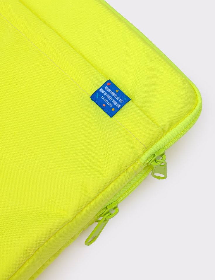 an open yellow bag with a blue label on it's side and zippered closures