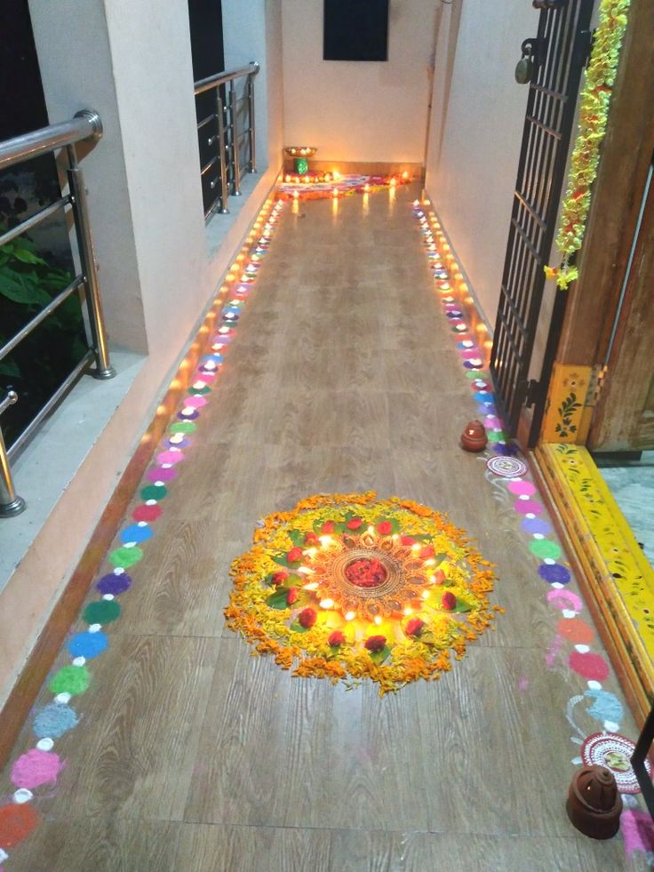 a hallway decorated with flowers and candles for diwaling