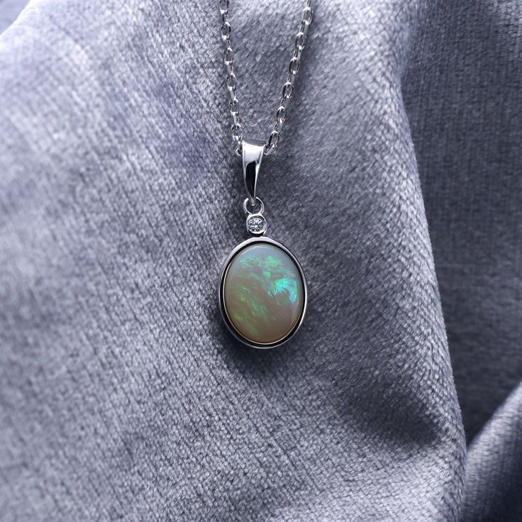 925 Sterling Silver Natural Australian Crystal White Opal Pendant Necklace | October Birthstone | Fine Gemstone Jewelry | Gift Opal is the queen of gemstone, which is one of the most beautiful gemstones in the world. Every piece of opal is unique. Its optical effect is Play-of-Color, which shows a vivid play of iridescent color. The colors change when the stone is viewed with various angles. We only use natural opal (no synthetics) for our jewelry. This elegant pendant necklace is simple, delica Elegant Opal Jewelry With Cabochon, White Gold Opal Necklace As Gift, Elegant Opal Cabochon Jewelry, White Gold Opal Necklace For Gift, Luxury Silver Opal Jewelry, Sterling Silver White Gold Necklaces With Natural Stones, Formal Gemstone Birthstone Necklace, Silver Sterling Oval Birthstone Necklace, Luxury Oval Opal Necklaces