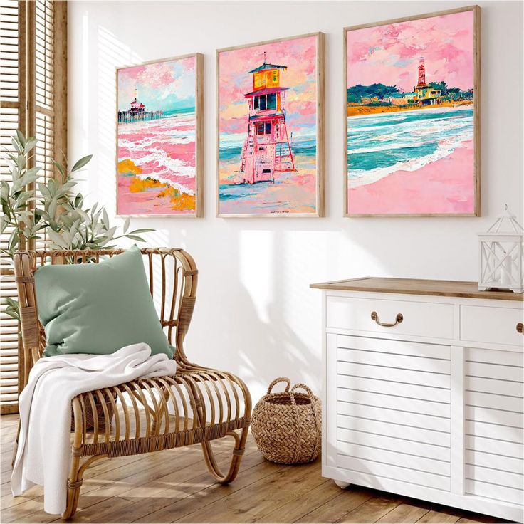 three paintings hang on the wall next to a chair and sideboard in a room