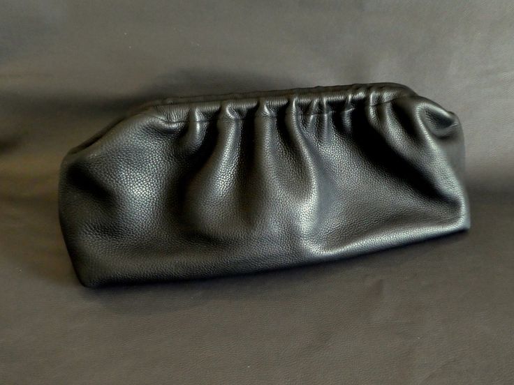 Indulge in luxurious functionality with our Cloudy Chic Leather Clutches collection! Crafted from genuine black leather, each piece is meticulously handmade to perfection. Elevate your style with our extra-large dumpling and retro puffball bags, designed to make a statement while providing ample space and durability. Whether you're heading to work or a night out, these oversized beauties are sure to turn heads. Embrace timeless elegance and practicality with our handmade creations, exclusively f Leather Satchel Pouch For Evening, Versatile Black Evening Bag With Removable Pouch, Evening Leather-lined Pouch, Black Everyday Clutch, Modern Black Evening Pouch, Black Satchel Pouch For Evening, Versatile Black Clutch, Black Soft Leather Evening Bag, Black Soft Leather Clutch For Evening