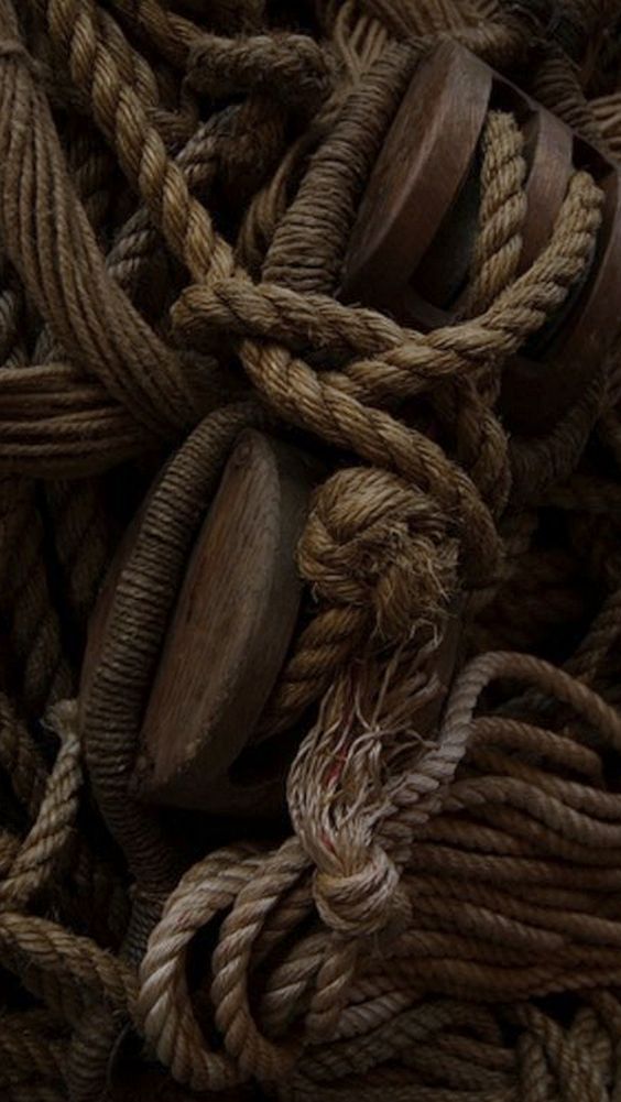 many ropes and wooden buttons are piled on top of each other in this close up photo