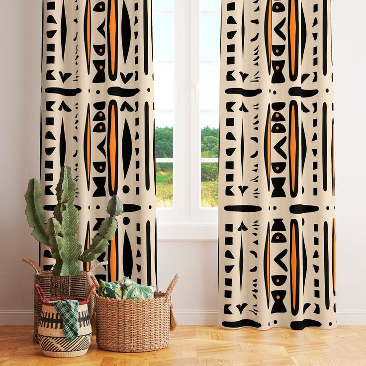 the curtains in this room are decorated with african style patterns and geometric shapes, along with a cacti basket