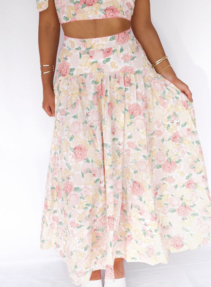 Introducing our Lush Garden Midi Skirt - the ultimate two-in-one outfit for any occasion. With its charming floral skirt and coordinating tie tank, you'll be ready for a bridal shower or fancy tea party in no time. Perfect for those who enjoy the sweeter things in life! Fabric 100% Rayon Floral Print Flowy Skirt For Garden Party, Spring Vacation Maxi Skirt With Gathered Detail, Spring Vacation Gathered Maxi Skirt, Spring Flowy Gathered Maxi Skirt, Flowy Gathered Maxi Skirt For Spring, Casual Tiered Maxi Skirt For Garden Party, Feminine Tiered Maxi Skirt For Vacation, Floral Print Summer Maxi Skirt For Day Out, Lightweight Maxi Skirt For Spring Day Out