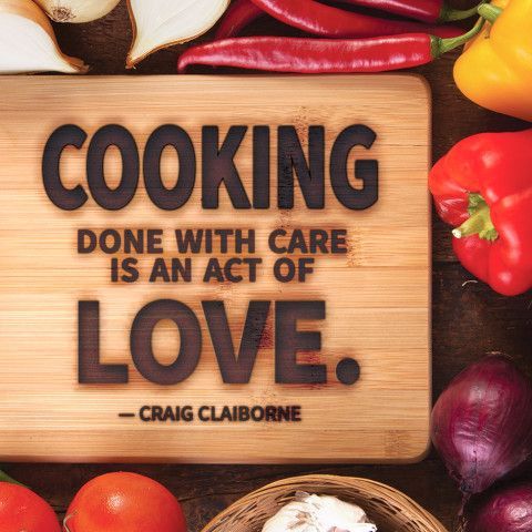 a wooden sign that says cooking done with care is an act of love, surrounded by vegetables and fruit