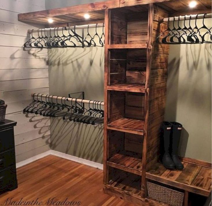 a wooden shelf filled with shoes next to a wall mounted coat rack and shoe rack