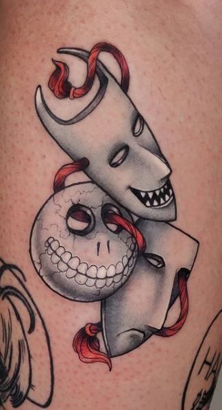 a tattoo with a skull and a knife on it