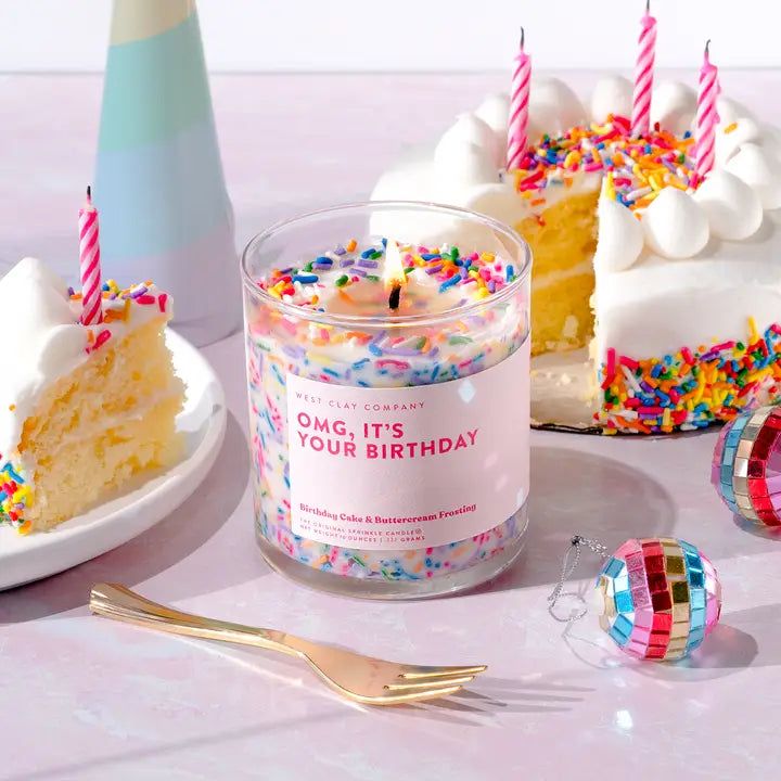 a birthday cake is next to a candle and some confetti