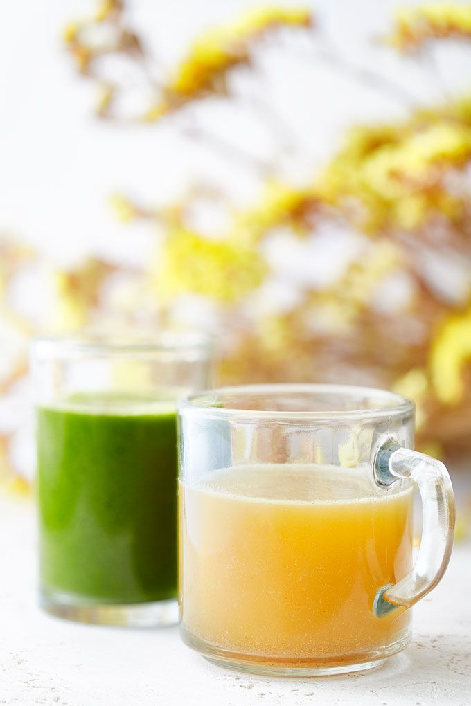 two glass mugs filled with green and yellow liquid