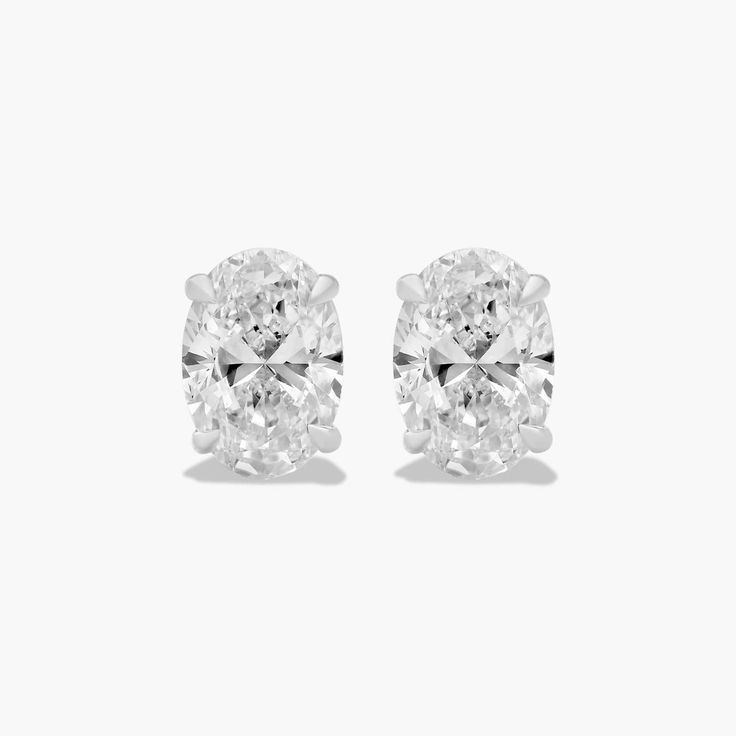 These classic oval-shaped diamond earrings are a timeless and elegant addition to any jewelry collection. The tapered basket setting showcases the unique beauty of the oval-shaped diamonds, which sparkle and shimmer with every move. The earrings are made of high-quality platinum, which is a durable and precious metal that will stand the test of time. Each earring features a single oval-shaped diamond that weighs approximately 1.00 carats in total. The diamonds are near-colorless (H-I color grade Luxury Oval Diamond Earrings For Formal Events, Luxury Oval Diamond Earrings For Formal Occasions, Luxury Oval White Gold Diamond Earrings, Luxury White Gold Oval Diamond Earrings, Luxury Oval Diamond Earrings With Accents, Luxury Oval Diamond Earrings For Anniversary, Luxury Gia Certified Oval Diamond Earrings, Classic Platinum Pear-shaped Diamond Earrings, Luxury Oval Diamond White Diamond Earrings