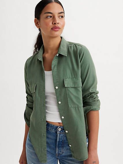 Inspired by classic workwear, our Doreen Utility Shirt features a timeless button-up front, two oversized patch pockets and versatile long sleeves that you can wear rolled up or down. A utilitarian-inspired shirt Cut with a standard fit With a button-up front Features two oversized patch pockets With adjustable long sleeves Long Sleeve Button Up Shirt Outfit, Button Down Outfit, Utility Shirt, Shirt Blouses Tops, Loose Jeans, Jeans Bootcut, Levis Women, Women Shirts Blouse, Dark Forest