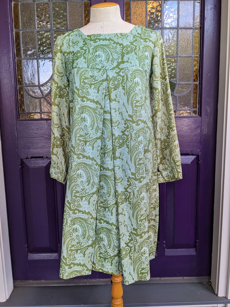 "Cute little 1960s dress with a Baby Doll A Line shape and a wonderful paisley print in shades of green and turquoise.  I'm not sure if the fabric is an early polyester or a rayon blend.  The yoke is lined in sage green acetate, and the back zipper is metal.  There is a sort of ombre effect on both sides of the dress, along the sleeves and the sides of the dress body, which could be slight fading or intentional, but it's kind of pretty.  Otherwise, the dress is in excellent condition. About a si Retro Green Dress With Vintage Print, Green Long Sleeve Dress With Paisley Print, Green Long Sleeve Paisley Print Dresses, Green Paisley Print Long Sleeve Dresses, Embroidered Pajamas, Green And Turquoise, 1960s Dress, 1960's Dress, 60s Mod