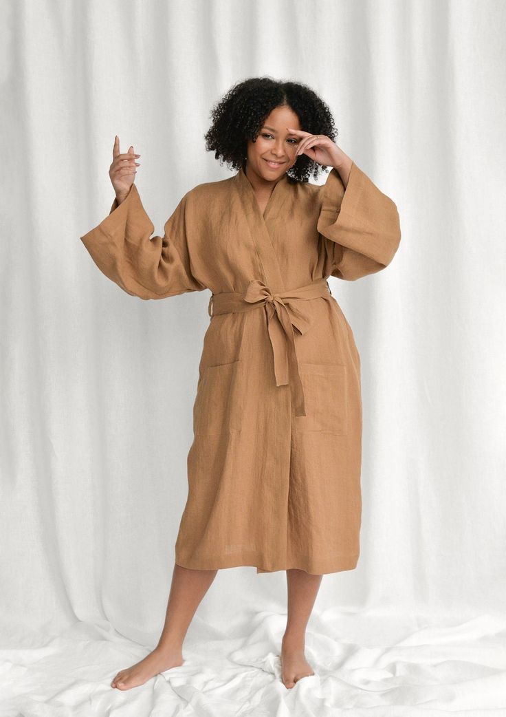 Spoil yourself with a linen bathrobe that's incredibly soft, light, and breathable. Handcrafted of premium quality European linen, this almond kimono-style bathrobe feels so good to the skin, you'll never want to take it off. The linen robe features a relaxed fit, long sleeves, an adjustable waistband, and comfy outer pockets, making it the ultimate addition to your at-home wear. The model is 175 cm (69'') tall and is wearing a bathrobe in size S/M. DETAILS - Handmade from high-quality European Elegant Linen Summer Robe, Elegant Summer Linen Robe, Summer Daywear Robe, Spring Linen Loungewear Robe, Summer Linen Relaxation Robe, Summer Linen Loungewear Robe, Summer Linen Robe For Loungewear, Summer Linen Robe For Relaxation, Relaxed Linen Summer Robe