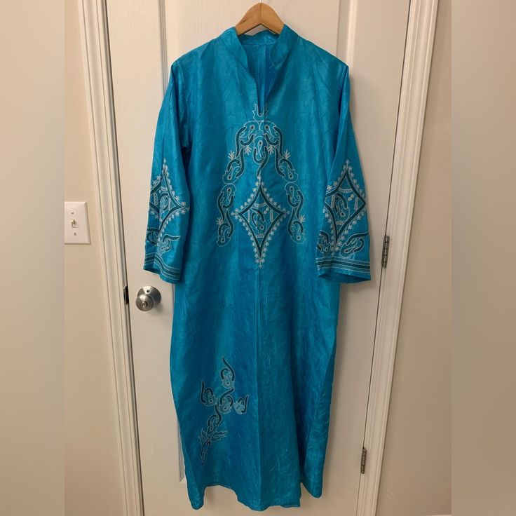 Nwot Came With Light Fabric Defects! Hardly Visible But There Are Different Spots Of The Fabric Looks Darker Than Others. This Would Usually Sell For $150 But Due To Defect There Price Is Discounted! True To Color! Has Silver And Different Shades Of Blue Embroidered Design Throughout The Dress And Sleeve Area! This Is Made In Saudi Arabia And Is A True To Size L. Dimensions Listed Below. It Is Very Cute For Ramadan Outings As Well! I Have A Small Middle Eastern Traditional Clothes And Souvenirs Blue Embroidered Straight Kurta Kaftan, Blue Long Sleeve Agbada For Wedding, Long Sleeve Embroidered Agbada For Festive Occasions, Long Sleeve Embroidered Agbada For Festivals, Blue Long Sleeve Agbada For Eid, Blue Long Sleeve Thobe For Eid, Elegant Blue Agbada For Festive Occasions, Elegant Blue V-neck Kurta, Blue Agbada With Dabka Detail