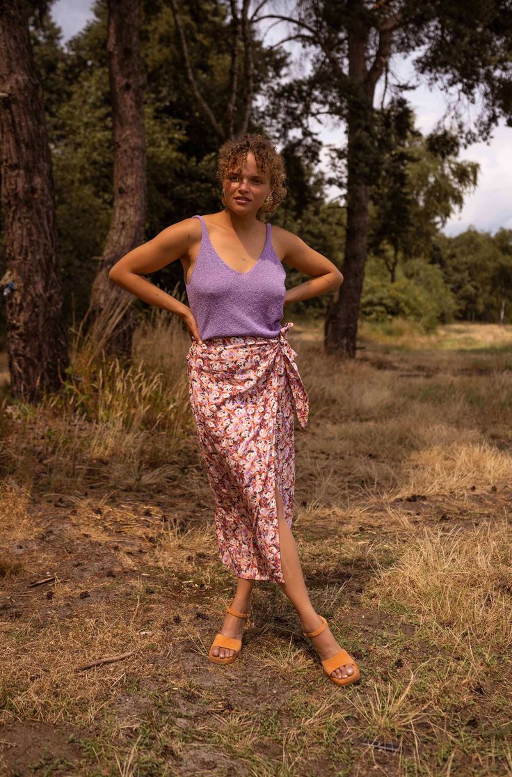 Floral print midi skirt with a beautiful wrap front detail that has an adjustable bow on the side. The skirt has a zipper on the back for ease and also is super flowy and airy which is perfect for the summertime. Our models wear the Purple Neda Top Sizes : S-M / M-L S-M: Length 34.25 in - Width 13.78 inM-L: Length 35.43 in - Width 14.96 in Contexture: 60% viscose - 40% cotton Washing: handwash recommended Clothes Europe, Zebra Print Skirt, Floral Print Midi Skirt, Parisian Women, Colors Purple, Beige Light, Printed Midi Skirt, Women's Summer Fashion, Printed Skirts