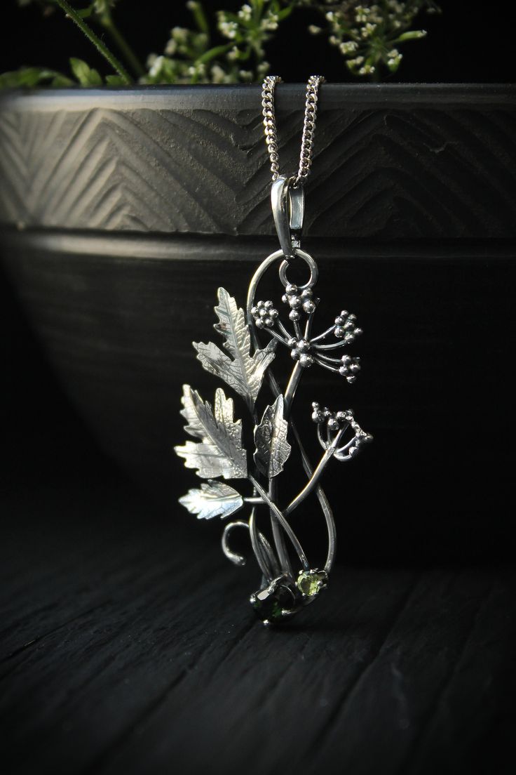 ITEM DESCRIPTION: The size H 5 cm x W 3 cm (2 x 1 1/3 inch). Weight - 5 g. You can buy it with a silver chain or without it. Even simple plants look very elegant. I made one of sterling silver, pretty green tourmaline, and peridot. This unique botanical jewelry looks like a real treasure of wild forest. It is really worthy of being in your precious collection. Expect many compliments on this! This handmade necklace will come to you in a gift box - ready for gifting. The parcel will be sent durin Silver Engraved Nature-inspired Necklace, Nature-inspired Engraved Silver Jewelry, Nature-inspired Sterling Silver Jewelry With Large Pendant, Silver Nature-inspired Round Pendant Jewelry, Silver Round Pendant Jewelry With Nature-inspired Style, Green Sterling Silver Flower Pendant Jewelry, Nature-inspired Engraved Flower Pendant Necklace, Silver Nature-inspired Necklace With Flower Charm, Nature-inspired Sterling Silver Jewelry