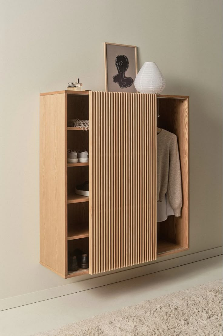 a wooden cabinet sitting on top of a carpeted floor next to a white wall