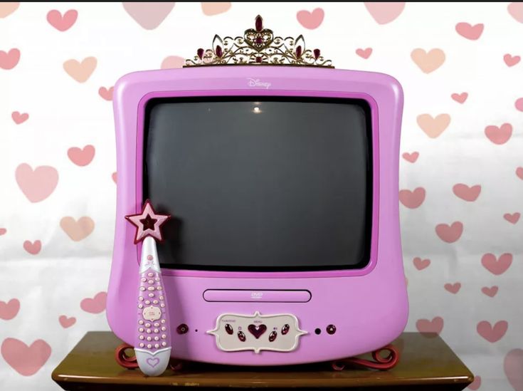 an old computer with a princess crown on top and a pink star next to it