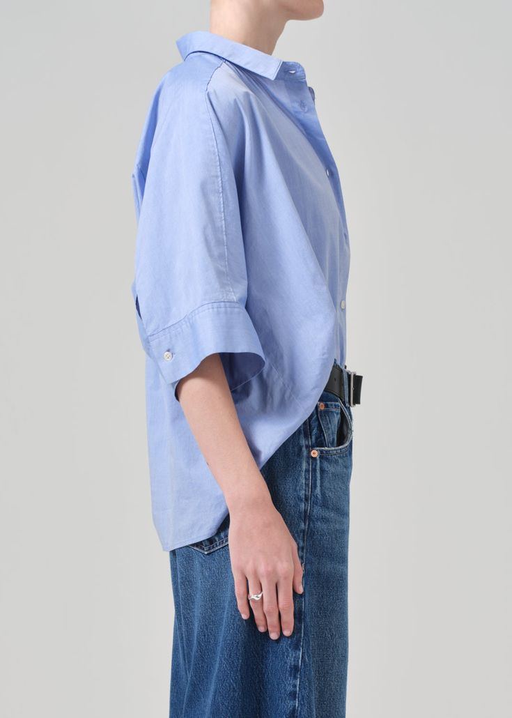 Made from crisp cotton-poplin, the Claire Origami Shirt has a loose fit, oversized sleeves and a classic pointed collar. This fit is true to size. Looks Like: Cornflower blue Feels Like: Ultra-lightweight cotton with an airy hand From our HUMANITY Collection Blue Tops With Roll-up Sleeves For Daywear, Blue Relaxed Fit Blouse With Cuffed Sleeves, Blue Blouse With Relaxed Fit And Cuffed Sleeves, Blue Blouse With Cuffed Sleeves Relaxed Fit, Blue Blouse With Rolled Sleeves And Relaxed Fit, Blue Blouse With Cuffed Sleeves And Relaxed Fit, Blue Shirt With Roll-up Sleeves And Shirttail Hem, Blue Cotton Tops With Cuffed Sleeves, Blue Tops With Rolled Sleeves For Everyday