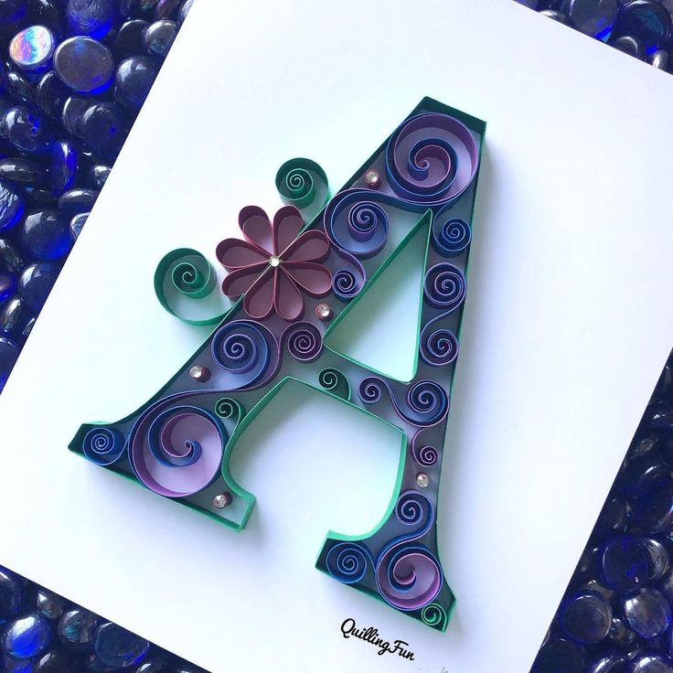 the letter a is decorated with swirls and flowers