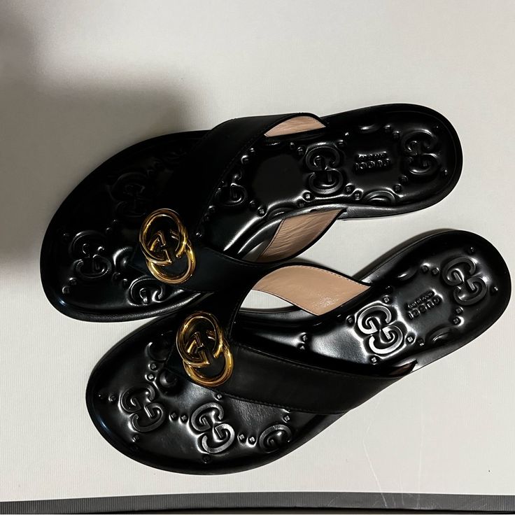 Beautiful Decoration And Can Be Worn In Any Occasion! Excellent Condition, Almost Never Worn! Gucci Designer Sandals With Single Toe Strap, Designer Gucci Sandals With Single Toe Strap, Gucci Flat Sandals With Leather Sole, Gucci Luxury Sandals With Leather Sole, Gucci Luxury Sandals With Cushioned Footbed, Designer Slides With Leather Sole And Round Toe, Luxury Gucci Sandals With Cushioned Footbed, Designer Slides With Round Toe And Leather Sole, Gucci Black Sandals With Single Toe Strap