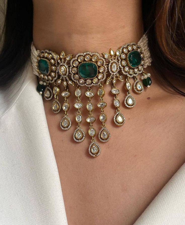 Gorgeous Sabyasachi inspired Fine Victorian Kundan  Emerald Green Doublet Stone choker Necklace with matching earrings. This choker is flexible and takes the shape of the neck. Fine quality and craftsmanship. Perfect for desi weddings. Necklace comes in drawstring cord therefore adjustable Please let me know if you have any questions *Please Note as these are Doublet stone there May be a Color Variations brain a natural Stone* Customized orders takes 3 to 4 weeks, depending on piece requirements Luxury Emerald Kundan Necklace For Wedding, Luxury Dual-tone Kundan Necklace For Celebrations, Luxury Jeweled Kundan Necklace For Festivals, Luxury Kundan Necklaces For Rituals, Luxury Kundan Necklace For Reception With Round Beads, Luxury Kundan Temple Necklace With 17 Jewels, Luxury Hallmarked Kundan Necklace For Ceremonial Occasions, Maharani Jewellery Set, Luxury Temple Jewelry Choker For Festive Occasions