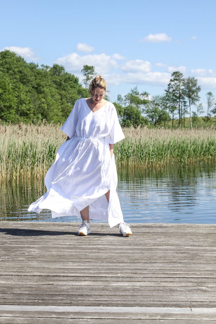 "A lovely loose dress is created for free-flowing women and is made from natural linen. This caftan dress is a loose fit, with flowing sleeves and the long length gives you a perfect waving. This linen summer dress is best for wearing at the beach, lounging at home, or even for a cozy evening walk. The drawstring waistline is adjustable by the long tie, dress has side pockets and not high side splits. One size: waist width with drawstring tie about 150cm (when not tied) dress width about 110cm o Flowy Linen Maxi Sundress, Summer Linen Tunic Dress, Linen Sundress With Relaxed Fit, Bohemian Oversized Linen Dress For Beach, Flowy Lagenlook Dress For The Beach, Linen Lagenlook Maxi Dress With Relaxed Fit, Flowy Linen Maxi Dress For Summer, Beach Long Dress With Relaxed Fit, Relaxed Fit Linen Sundress