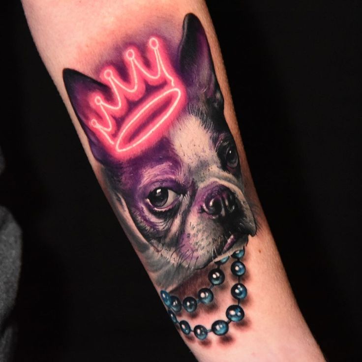 a dog with a crown on it's head has a pearl necklace around its neck