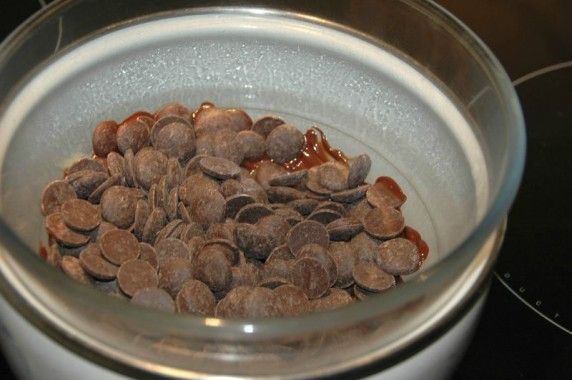 a bowl filled with nuts sitting on top of a stove