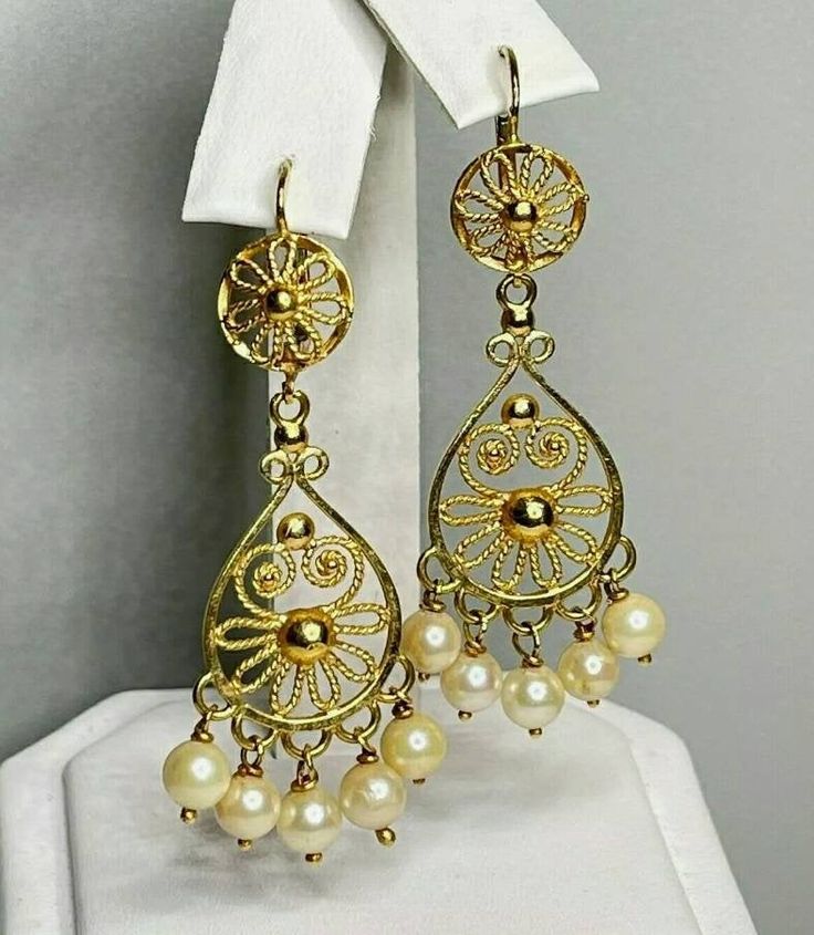 "Gorgeous vintage chandelier earrings! Pair of Marked 750 (18K) yellow gold saltwater cultured pearl chandelier style pierced earrings. Attached to the earrings are well made leverback style earring fasteners, designed to match the chandelier earring. Each saltwater cultured pearl measures approximately 4.80 mm x 4.80 mm. Each earring measures approximately 1 3/4\" long x 3/4\" wide. The pair of 18K yellow gold pearl earrings weigh 8.90 grams. The beautiful chandelier style earrings come in a qu Ornate Hallmarked Dangle Chandelier Earrings, Ornate Hallmarked Chandelier Dangle Earrings, Classic Yellow Gold Chandelier Earrings, Ornate Dangle Chandelier Earrings For Formal Occasion, Formal Ornate Dangle Chandelier Earrings, Victorian Gold Chandelier Earrings For Formal Occasions, Elegant Gold Chandelier Earrings, Pierced, Yellow Gold Elegant Chandelier Earrings, Classic Filigree Dangle Chandelier Earrings