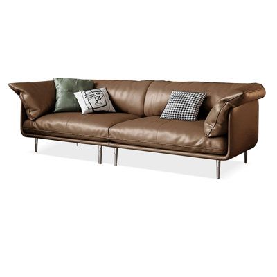 a brown leather couch with two pillows on it's back and the arms folded down