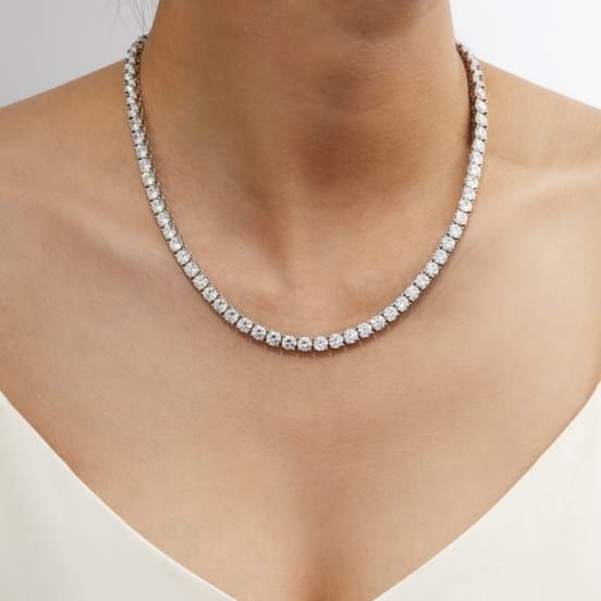 Bella Luce® white diamond simulant 43.50ctw round, platinum over sterling silver tennis necklace. Measures approximately 15, 16, and 17" L x 0.20" W and has a hidden box clasp closure. The diamond equivalent weight is 26.36ctw. Crystal Round Cut Tennis Necklace Fine Jewelry, Crystal Round Cut Tennis Necklace, Silver Cubic Zirconia Single Strand Tennis Necklace, Silver Single Strand Cubic Zirconia Tennis Necklace, Silver Single Strand Tennis Necklace, Silver Cubic Zirconia Tennis Necklace In Fine Jewelry Style, White Round Cut Crystal Tennis Necklace, Classic White Crystal Tennis Necklace, White Crystal Tennis Necklace