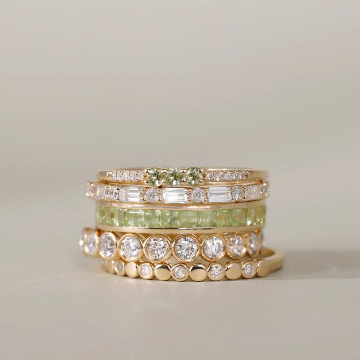 Adorn your finger with our Peridot Full Eternity Ring, a radiant celebration of August's birthstone. This exquisite piece showcases the warm allure of the green gemstone in a princess cut, offering a perfect blend of sophistication and individuality. Elevate your style with this timeless and vibrant symbol of elegance. Classic Green Multi-stone Diamond Ring, Green Multi-stone Diamond Ring, Elegant Green Diamond Eternity Band, 14k Gold Green Diamond Princess Cut Ring, Green Princess Cut Diamond Ring In 14k Gold, Princess Cut Green Diamond Ring In 14k Gold, Classic Green Stackable Diamond Ring, Classic Green Gemstone Eternity Band, Luxury Stackable Emerald Wedding Ring