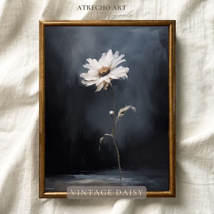 a white flower sitting on top of a black and white background in a wooden frame