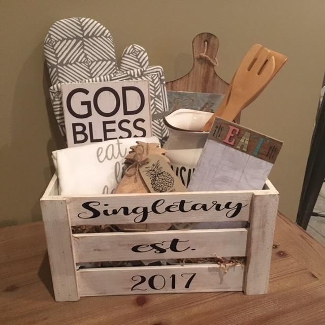 a wooden crate filled with kitchen items on top of a table