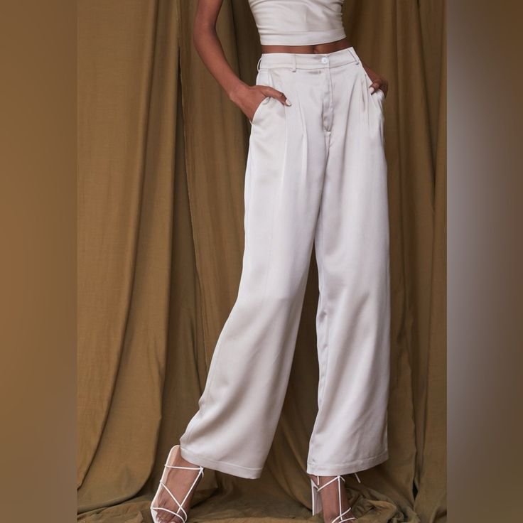 Materials: Champagne Satin Pant Breezy Throughout The Legs That Allows For Fluid Movement Zipper And Button Closure Pleated Detail At The Waist Mid Rise Fit Belt Loops Allow For Additional Styling Functional Pockets At The Hips Non-Functional Welt Back Pockets 100% Polyester Hand Wash Cold Do Not Bleach, Lay Flat To Dry, Low Iron If Desired Runs True To Size Spring Satin Straight Leg Pants, Fitted Satin Bottoms With Straight Leg, Fitted Satin Straight Leg Bottoms, Casual Satin Straight Leg Pants, Casual Straight Leg Satin Pants, Wide Leg Satin Pants With Pockets, Summer Satin Straight Leg Bottoms, Solid Bottoms With Button Closure For Night Out, Fitted Satin Pants For Summer