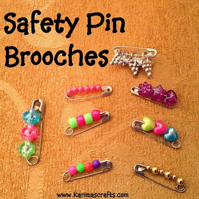 several safety pin brooches on a table with the words safety pin brooches