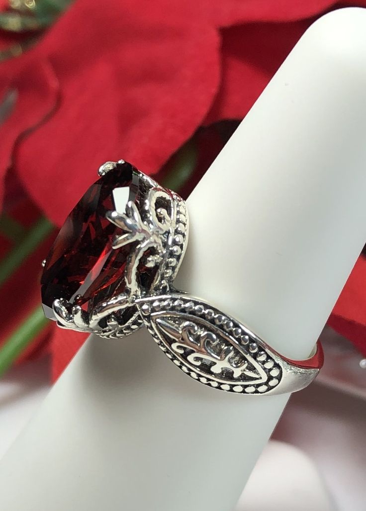 Garnet Ring Dragon Design #133 MADE TO ORDER This lovely sterling silver filigree ring is set with a stunning approximately 6ct Red Garnet CZ, {6ct Natural Garnet gemstone also available, see last picture in set}. The oval-cut Garnet gemstone is 14mm long by 10mm wide. The ring is 8mm off the finger. Notice the detailed design of the silver filigree setting and band. This is an exquisite rendition of a Gothic/Renaissance filigree ring... and is ready to wear. A ring gift-box is included. Feel fr Elegant Oval Ruby Ring For Gift, Silver Marquise Ruby Ring As Gift, Oval Garnet Jewelry With Prong Setting, Oval Garnet Rings, Oval Filigree Ring With Accent Stones For Formal Occasions, Exquisite Filigree Ring With Gemstone For Gift, Formal Filigree Ring With Gemstone, Exquisite Gemstone Filigree Ring As A Gift, Filigree Ring With Center Stone As Gift