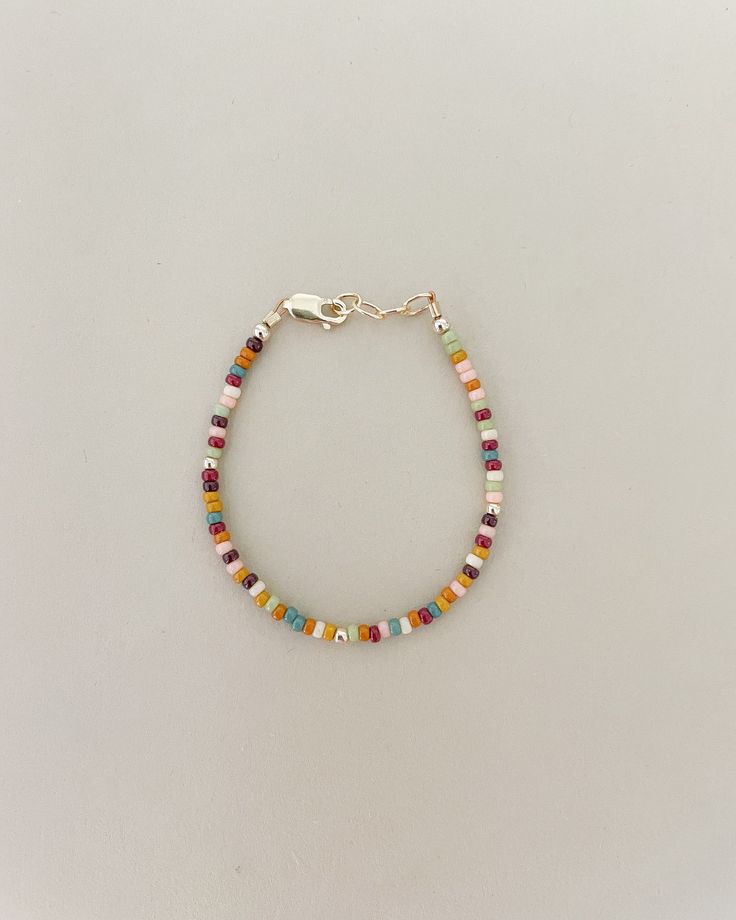 2mm beautiful rainbow dainty beads will be your new favorite layer bracelet this year! The warm and pretty tones of the rainbow beads will have you fall in love with the detail!  This beautiful Handmade bracelet is a perfect gift for anyone! Mamas, toddlers and children love these bracelets made to last. Order a matching bracelet for you and your little ones. Our Bracelets are Handmade in the USA and are made with high quality 14K gold filled attachments. They are beautiful and add the perfect a Adjustable Rainbow Beaded Bracelets For Everyday, Everyday Adjustable Rainbow Beaded Bracelets, Bohemian Heishi Beads Friendship Bracelets, Everyday Rainbow Round Bead Jewelry, Everyday Rainbow Jewelry With Round Beads, Everyday Bohemian Heishi Beaded Bracelets, Bohemian Multicolor Friendship Bracelets For Everyday, Bohemian Multicolor Friendship Bracelets, Everyday Multicolor Bohemian Friendship Bracelets