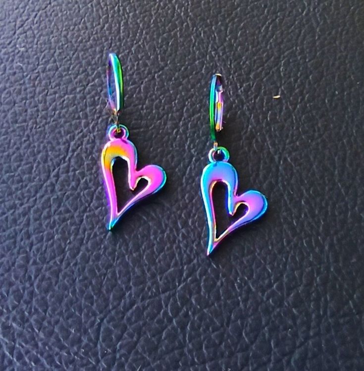 These rainbow titanium heart earring dangle dressed up or dressed down.  These dainty heart earring will be a lovely gift for her him women men, boyfriend and girlfriend gift. Small huggie hopp earrings length: approx. 1.5 x 0.6 inch = 3.8 x 1,5cm Gift wrapped and gift message available. Laser cut titanium rainbow heart earrings perfectly fashionable to complete any colourful outfit. No fading, durable, sturdy & super light electroplated stainless steel. Heart-shaped Surgical Steel Jewelry For Gifts, Trendy Hoop Earrings With Heart Charm, Trendy Heart-shaped Hoop Earrings For Gift, Trendy Drop Earrings For Valentine's Day, Colorful Drop Earrings As A Gift, Trendy Valentine's Day Drop Earrings, Trendy Dangle Stainless Steel Jewelry, Trendy Stainless Steel Dangle Jewelry, Rainbow Nickel-free Drop Earrings