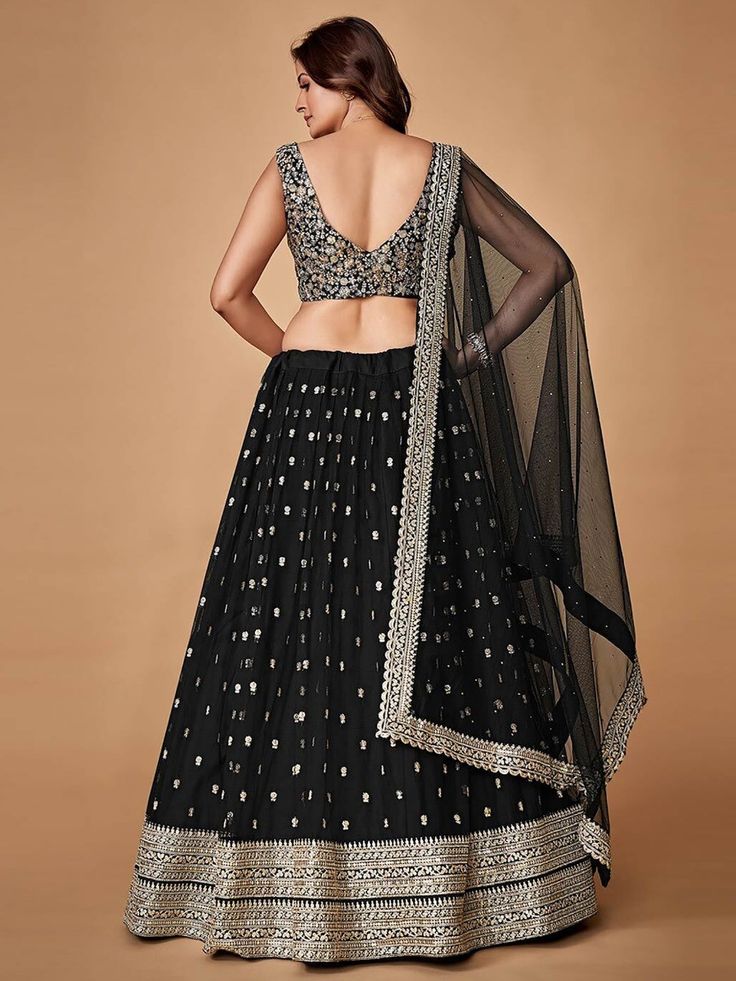 Bring back the traditional charm to your closet with this exceptional black color lehenga choli in heavy net material embellished with double sequins and zari embroidered featured with attached canvas.
This lehenga comes in a black color choli in heavy net material with a silk inner and a heavy soft net dupatta featuring sequins, stonework, and zari embroidered work.
This lehenga semi-stitched up to 44 inches comes with unstitched blouse material.
Women can buy this lehenga choli to wear for the Semi-stitched Embellished Black Anarkali Set, Black Georgette Bollywood Sharara, Black Bollywood Style Georgette Sharara, Black Sharara With Dupatta For Party, Party Black Anarkali Set With Sheer Dupatta, Black Sharara For Diwali Party, Party Semi-stitched Black Sharara, Black Choli With Sheer Dupatta For Eid, Black Sharara With Zari Work For Diwali