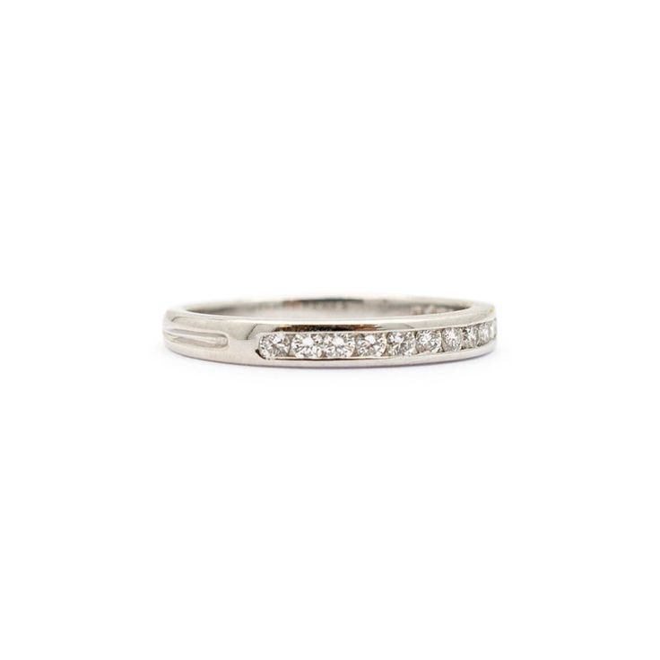 Brand: Tiffany & Co.  Gender: Ladies  Metal Type: Platinum  Size: 6  Shank Maximum Width: 2.50 mm  Weight: 3.00 grams  Ladies 950 platinum diamond wedding band with a half-round shank. Engraved with "PT950".  Pre-owned in excellent condition. Might shows minor signs of wear.  Channel Set in 950 Platinum with:  Eleven (11) round brilliant cut natural diamonds:  Measurements: 1.40mm - 1.50mm in diameter x ~0.88mm in depth. Weight Range: 0.013 ct. - 0.015 ct. Estimated Total Weight: 0.150 ct. Color Classic Diamond White Stackable Rings With Half Eternity, Classic Half Eternity Stackable Rings In Moissanite, Channel Set White Gold Band, White Gold Channel Set Bands, Classic Platinum Diamond Ring Channel Set, Classic Platinum Diamond Ring With Channel Set, Classic Promise Bands With Diamond Accents, Classic Brilliant Cut Bands For Promise, Classic Bands With Single Cut Diamonds For Promise Ring