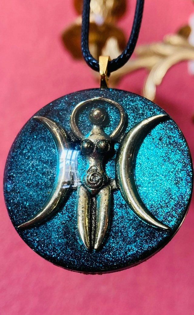 This is a beautiful Goddess resin pendant, with an antique brass symbol of the Triple Moon Goddess. It is approx. 1,75 inch (4cm) and manufactured in high quality resin. The necklace is a black leather chain. The pendant is delivered in a nice pouch. Please note that each pendant is unique and that the end result may not be entirely similar to the pictures. This is due to the fact that the colors blend in their own way, which is never the same twice. The main colors will remain the same though. Celestial Resin Jewelry As A Gift, Celestial Resin Jewelry For Gifts, Celestial Resin Jewelry As Gift, Celestial Style Resin Jewelry For Gifts, Handmade Celestial Resin Jewelry, Chalice Well, Goddess Moon, Star Goddess, Triple Moon Goddess