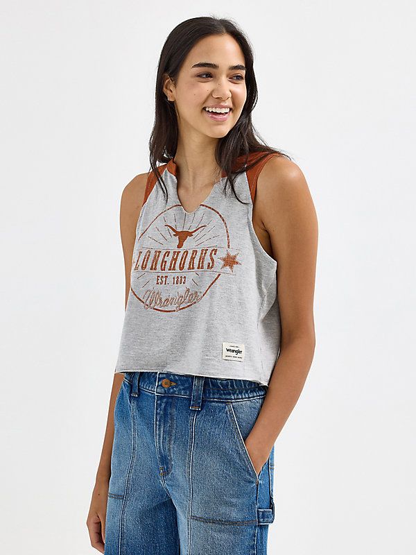 Discover your new go-to for every game in the Women’s Wrangler® Collegiate Vintage Muscle Tee. This vintage-inspired sleeveless muscle tank delivers the school spirit you want, with a distressed print of your team's logo, name, and founding date across the front. It’s crafted from a comfortable cotton blend, complete with a raw edge hem, a cropped length, and your team’s color at the shoulders. This graphic tank will quickly become your go-to for game day. Spring Cotton Racerback Muscle Tee, Sporty Tank Top For College In Summer, Sporty Summer Tank Top For College, Casual Summer Tank Top For College, Sleeveless Tops For College Summer, Sleeveless Summer Tops For College, Casual Sleeveless Tank Top For College, Cotton Tank Top For College In Summer, Cotton Relaxed Fit Racerback Top