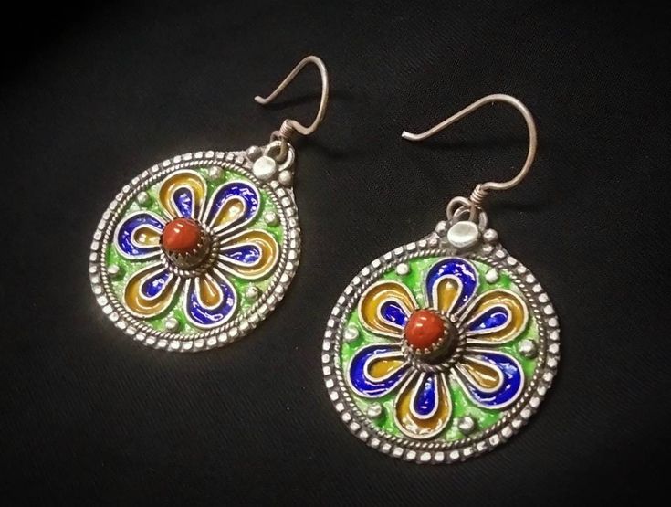 Vintage Algerian earring from the Grand Kabyle region, Sterling Silver enamelled in blue, green and yellow color and inlaid with real coral cabochon. ✓ Height: 5 cm. ✓ width: 3 cm. ✓ Material: sterling silver and real coral. ✓ Total weight: 13 grs. ✓ Origin: Grand Kabyle region - Algeria. ✓ Shipping will always be via DHL for free. ✓ Shipping to the USA from 3 to 7 business days. ✓ Shipping to Europe from 3 to 5 working days. ✓ Shipping to Japan from 4 to 7 business days. I have been working in Antique Jewelry With Matching Earrings For Festive Occasions, Antique Jewelry Set With Matching Earrings For Festive Occasions, Vintage Multicolor Jewelry With Matching Earrings, Antique Pierced Round Jewelry, Green Pendant Earrings For Festive Occasions, Traditional Multicolor Sterling Silver Earrings, Antique Pendant Earrings For Jewelry Making, Traditional Multicolor Nickel-free Jewelry, Traditional Multicolor Hallmarked Earrings